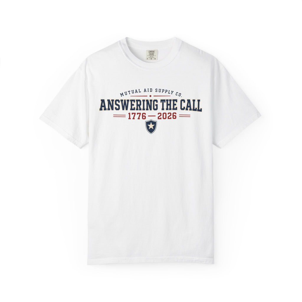 Answering the Call 1776–2026 heritage tee — navy athletic lettering with a shield and star on a light Comfort Colors shirt