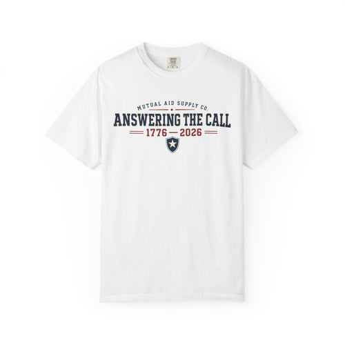 Answering the Call 1776–2026 heritage tee — navy athletic lettering with a shield and star on a light Comfort Colors shirt